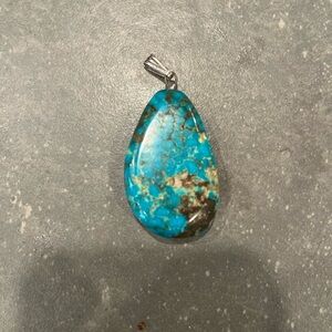 Turquoise colored stone pendant